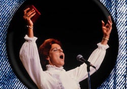 Anitta Bryant sings microphone with arms raised and book in her hand