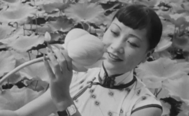 Anna May Wong holding a lotus flower