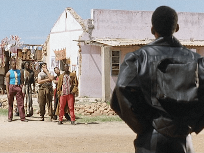 A man facing a group of men.