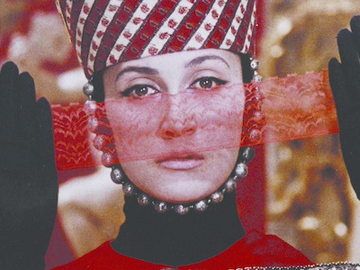 A woman holding a ribbon of lace in front of her face.