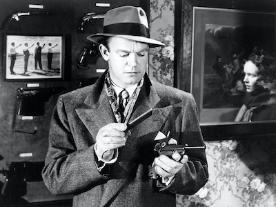 A man examining a gun.