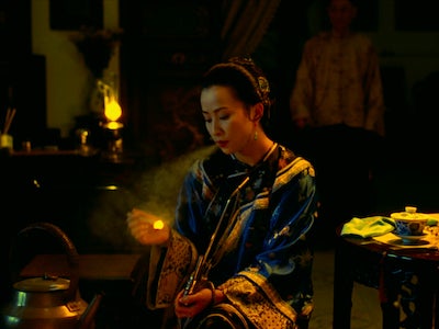 A woman smoking a pipe.