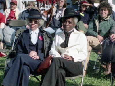 A group of people seated on a lawn.
