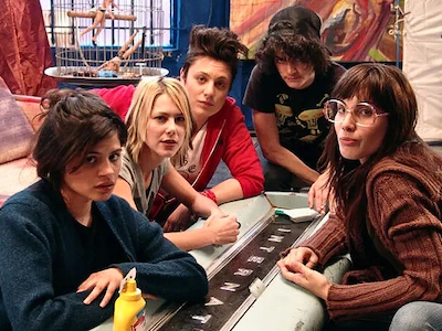 Five women sitting and looking at the camera.