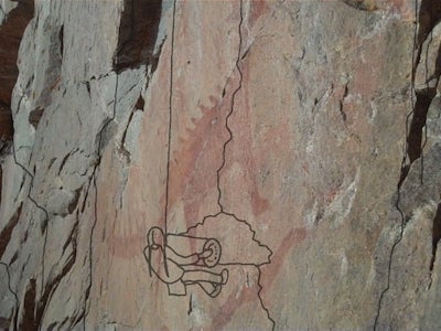 A drawing of a person against a mountain.