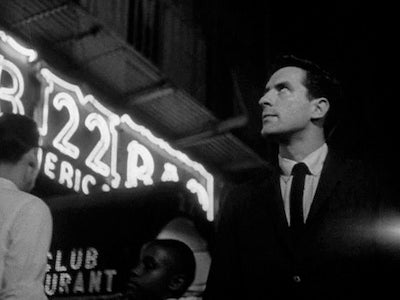 John Cassavetes in a night street scene.