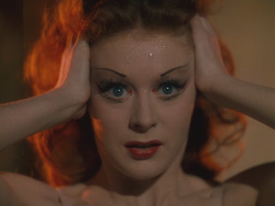 Moira Shearer with her hands on her head.