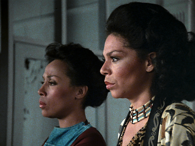 Two women shown in profile.