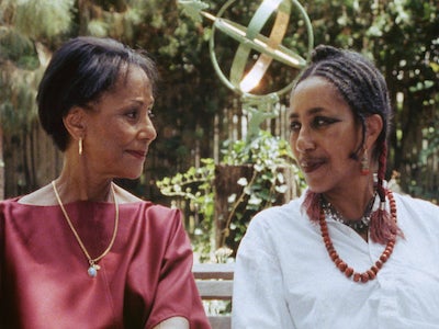 Two women smiling at each other in a 