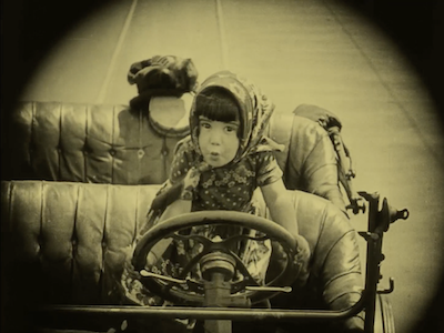 A young girl driving a car.