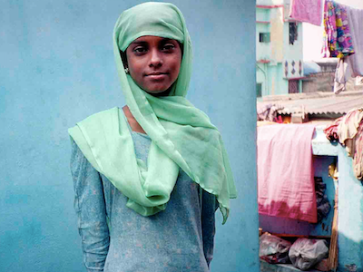A girl wearing a scarf over her head.