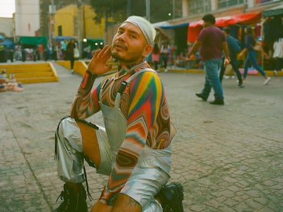 A person posing on a street.