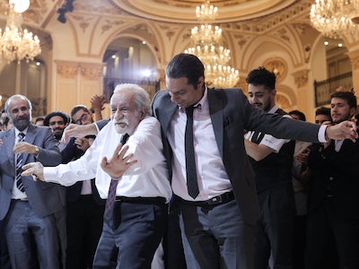 Men dancing in a ballroom.