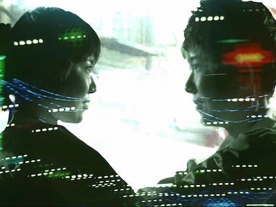 Two people smiling at each other.