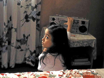 A girl playing a cassette tape player.