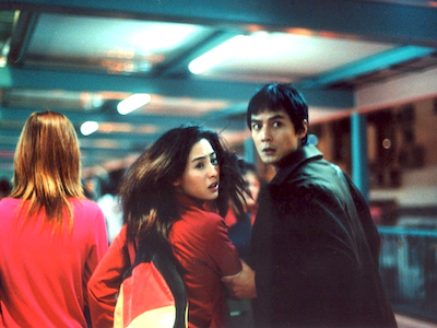A woman and man running from something.
