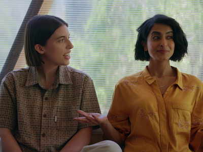 Two women sitting by a window.