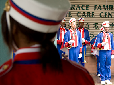 Teens in marching band uniforms.