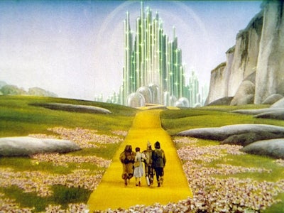 The lion, Dorothy, tin man and scarecrow walking to Oz.