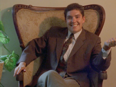 The subject of the documentary "Trans" (1994) sitting in an armchair.
