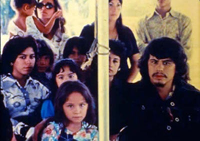 A group of Latinos looking at the camera.