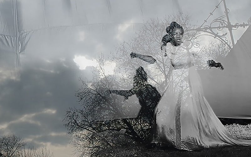 An ethereal image of a woman in a gown, superimposed over an image of the sky.