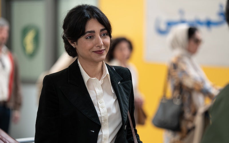 A woman smiling in an airport.