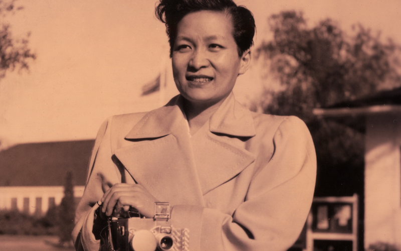 Esther Eng holding a camera.