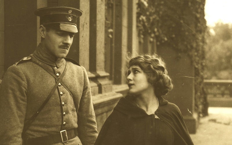 Mary Pickford looking at a man in military uniform.