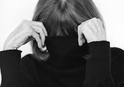 Joan Didion hides her face behind her turtleneck