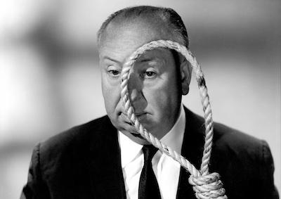 Alfred Hitchcock holding a noose to his face.