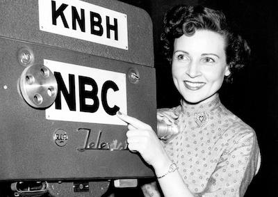 Betty White pointing to a camera labeled KNBH NBC.