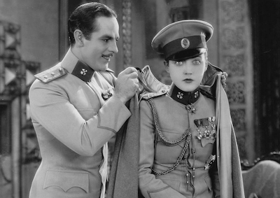 Actors Onslow Stevens and Marion Davies in uniforms.