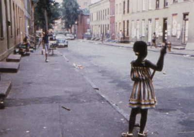 A child playing on a residential street.