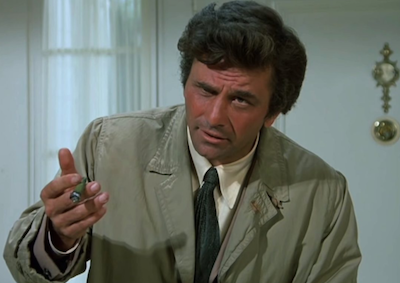 Peter Falk holding up a cigar.