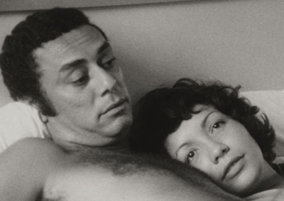 A man and woman lying in bed.