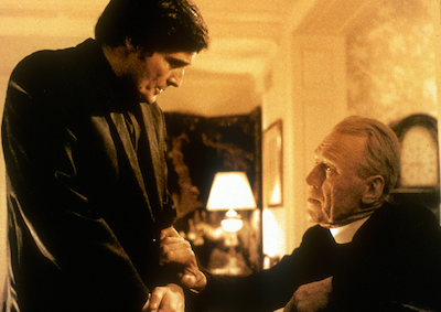 Two priests talking in a house.