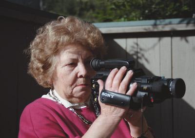 A woman holding a video camera.