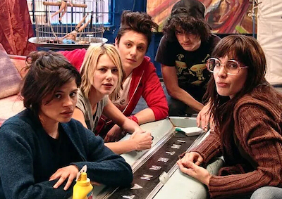 Five women sitting and looking at the camera.