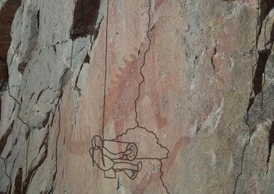 A drawing of a person against a mountain.