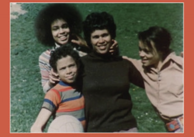 Three women and a boy smiling for the camera.