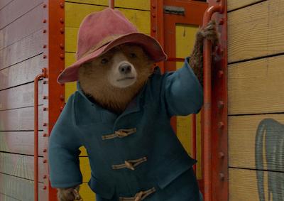 An animated bear hanging off a train.