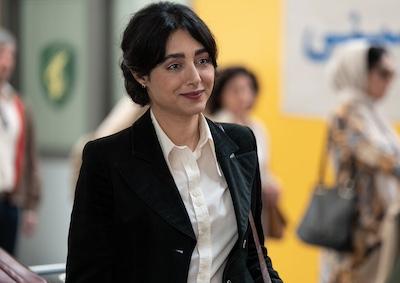 A woman smiling in an airport.