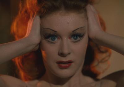 Moira Shearer with her hands on her head.
