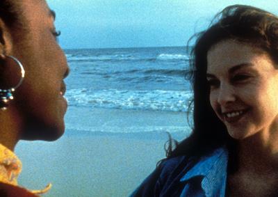 Two women smiling on the beach.