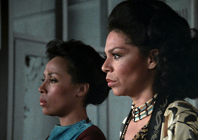 Two women shown in profile.