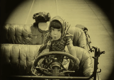 A young girl driving a car.