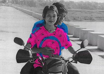 Two people riding a motorcycle.