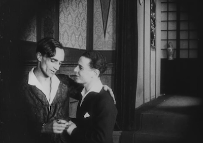 Conrad Veidt and Fritz Schulz talking to each other affectionately.