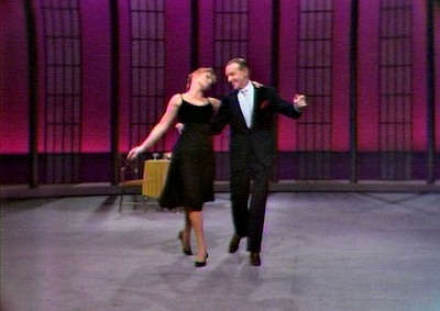 Barrie Chase and Fred Astaire dancing in a TV studio.